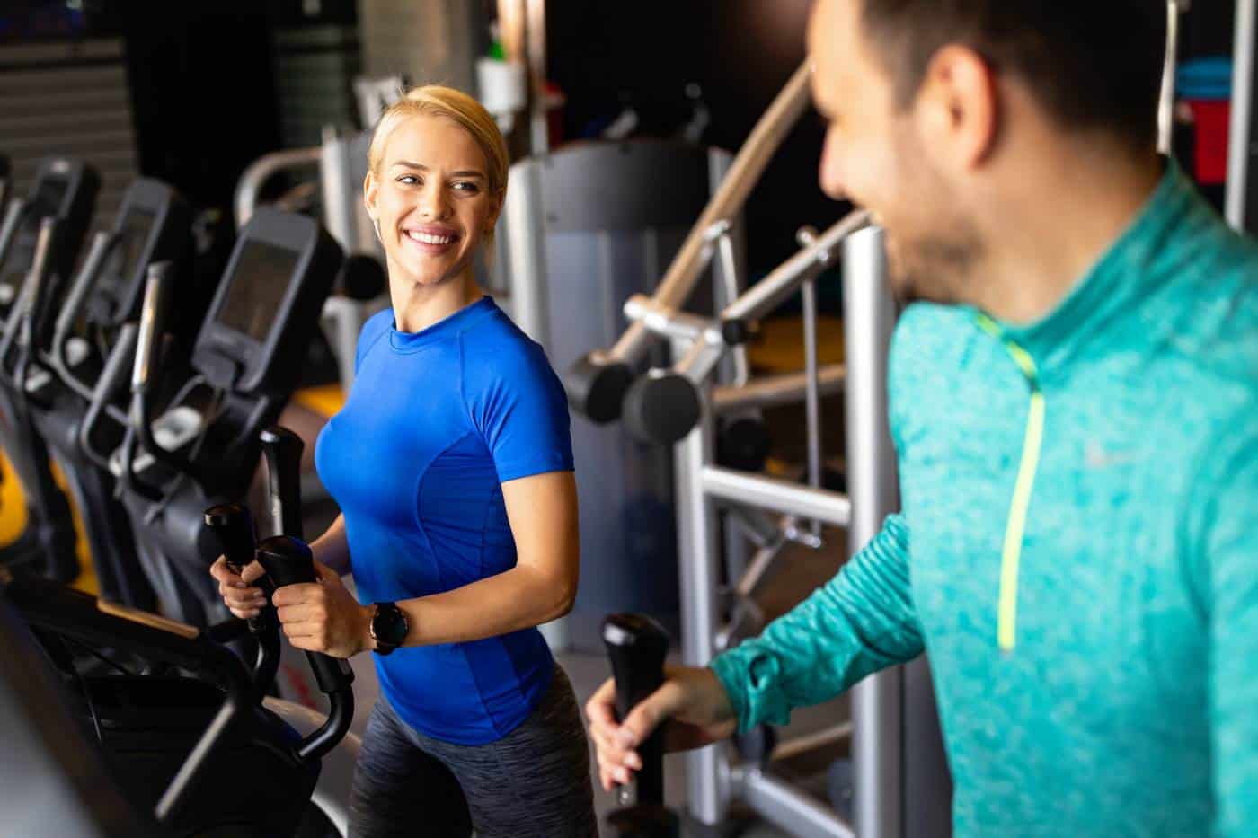 Happy people working out on treadmills in the gym