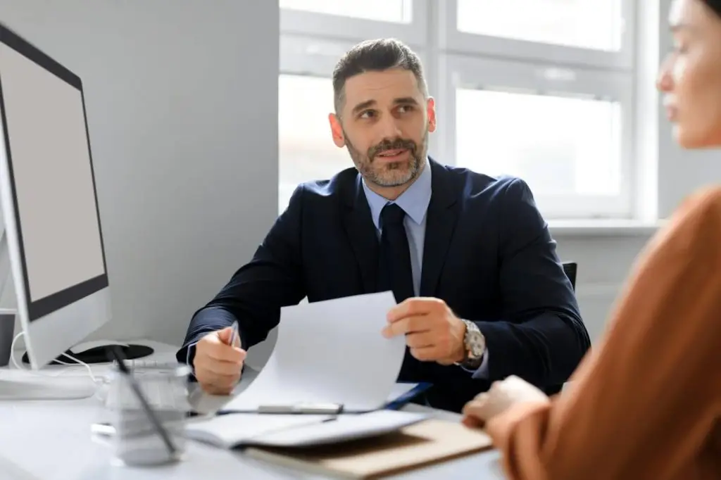 Employment concept. Businessman having job interview and talking with woman headhunter sitting at